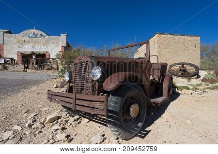 December 14 2015 Terlingua Texas: car wreck in front of the Chisos Movie Theater constructed in the 1930's nowadays functioning as a restaurant for tourists visiting the ghost town