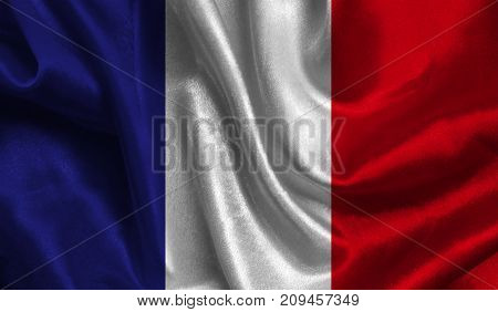 Realistic flag of France on the wavy surface of fabric. This flag can be used in design.