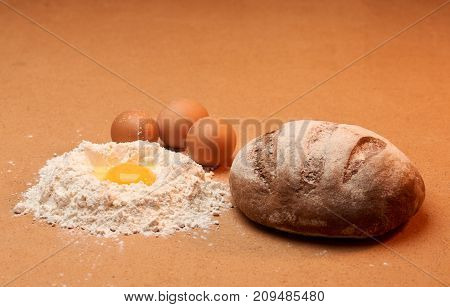 Bread, Three Eggs And An Egg Yolk Surrounded By Flour