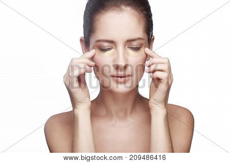 portrait of a girl on a white background with patches for the eyes