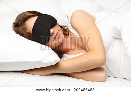 Young Woman Sleeping With Eyemask In White Bed