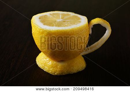 a cup of lemona cup of lemon on a wooden table