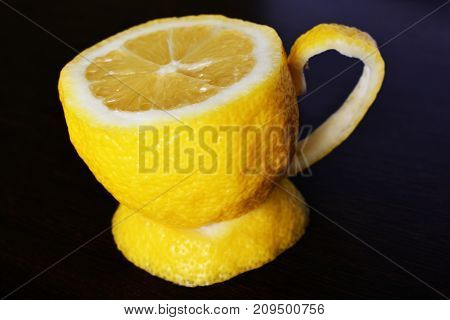 a cup of lemona cup of lemon on a wooden table