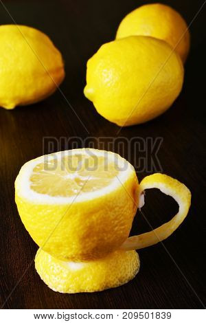 a cup of lemona cup of lemon on a wooden table