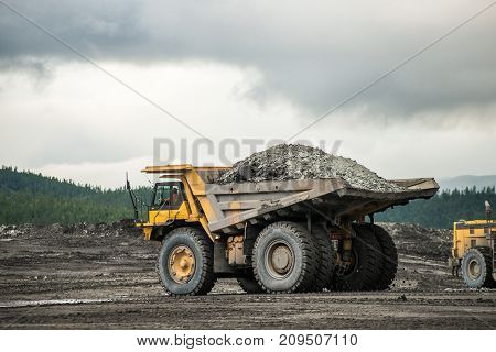 Production useful minerals. the dump truck yellow