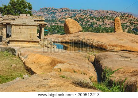 View of ancient ruins on Hemakuta hill in Hampi, Karnataka, India. Landscape with unique mountain formation with amazing stones tropical nature and temple. UNESCO World Heritage Site