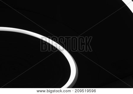 Arc of white light on black background