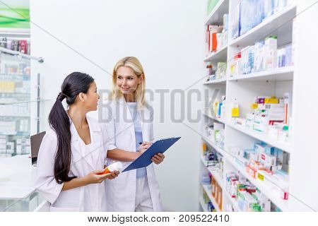 Female Pharmacists Working In Drugstore