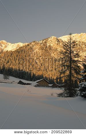 Big montain in the snow. Hut in the alps.