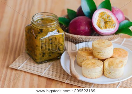 Homemade plain scones serve with passion fruit jam and. Scones is traditional English pastry for afternoon tea or coffee break. Delicious scones and passion fruit jam ready to served. Scones and passion fruit jam ready to served.