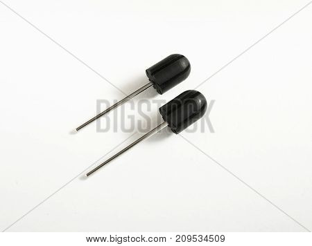 Two Sanding Cap Rubber Mandrels. White Backgound. Drill Bits, Same Sizes