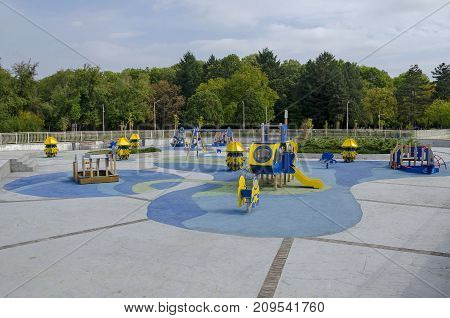 Autumnal view toward public garden with natural forest and new open-air kindergarten, Popular  North park,  

Vrabnitsa district, Sofia, Bulgaria