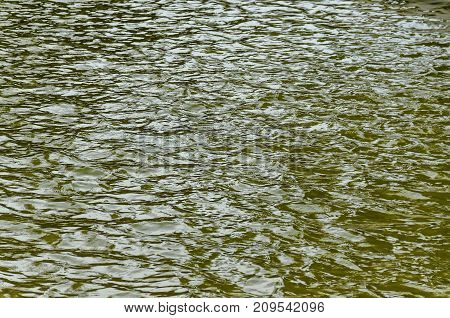 Interesting natural background of water with reflection at lake in Popular north park, Vrabnitsa district, Sofia, Bulgaria