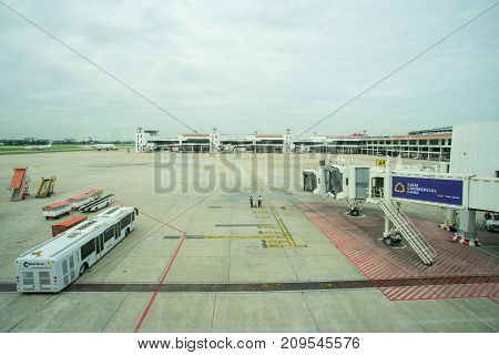 BANGKOK THAILAND  21 JULY 2017: Ground crew directing an incoming airplane into position to meet a jet-way bridge in Don Mueang international airport (DMK)