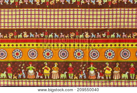 background: fragment of tablecloth in traditional Russian folk style with the images of Dymkovo toys also known as the Vyatka toys or Kirov toys