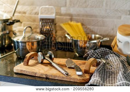 Kitchen utensils on wooden table knives spaghetti pasta