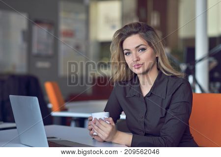 Young and beautiful businesswoman tired from work in the office.Woman holding her head