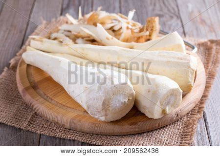 Purified parsnip on a cutting board on a wooden table