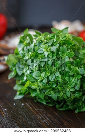 Bazil leaves on kitchen over wooden table