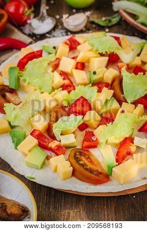 Tortilla with salad over it, surrounded by ingredients