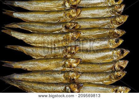 arrangement with lots of fresh smoked sprats in black back
