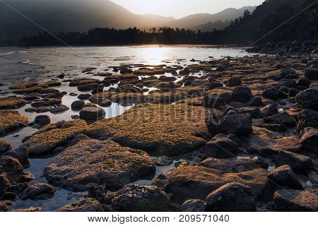 Rocky beach of Tioman Island at sunset