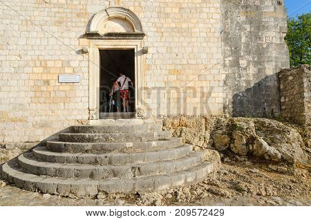 ULCINJ MONTENEGRO - SEPTEMBER 9 2017: Unknown tourists visit Archaeological Museum in Old Town Ulcinj Montenegro