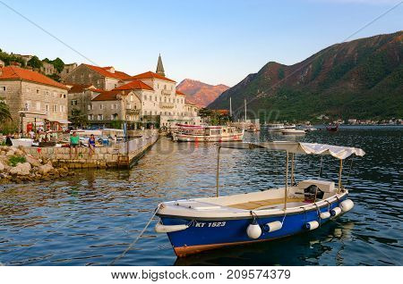 PERAST MONTENEGRO - SEPTEMBER 13 2017: Unknown people rest on seafront of popular resort town of Perast Montenegro