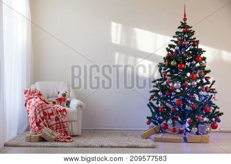 Christmas tree in a white room for Christmas with gifts 2