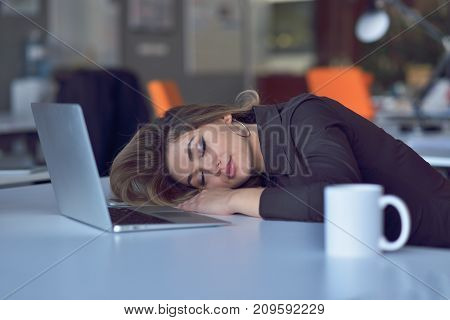 Young and beautiful businesswoman tired from work in the office.Woman holding her head