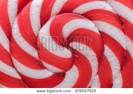 Foodbackground. Texture of colored candy on a stick: red and white