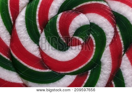Foodbackground. Texture of colored candy on a stick: red, white and green