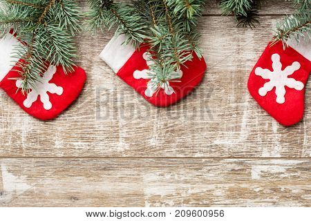 Fir tree branches and Christmas decorations are on the boards. Christmas background. Christmas Socks. New Year background. Xmax background. Christmas tree.