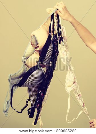 Female Hand With Many Bras To Wear