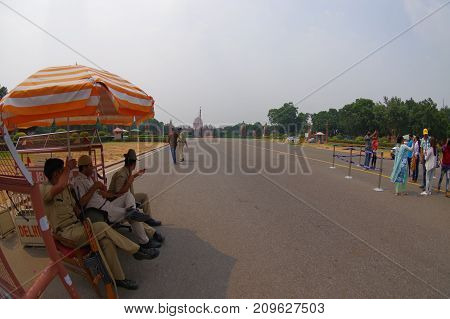 Jaipur, India - September 26, 2017: Police officers under an umbrella at the enter of the Goverment building of Rashtrapati Bhavan is the official home of the President of India.