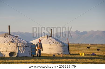 man coming out of mongolian ger in a landscape of northern Mongolia