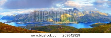 Sunny summer panorama of lofoten islands. Gorgeous noway landscape with blue fjords and green mountains.