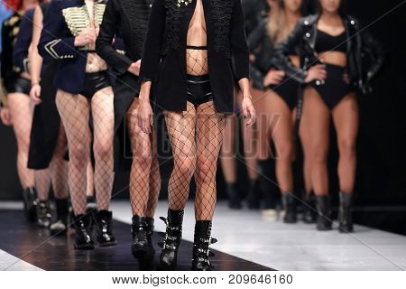 Sofia, Bulgaria - 28 September, 2017: Female models walk the runway in different dresses during a Fashion Show. Fashion catwalk event showing new collection of clothes. Naked legs.