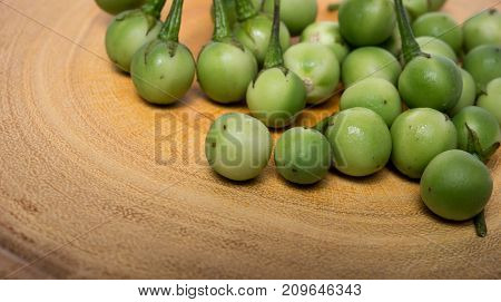 Turkey Berry (solanum Torvum) On Chopping Wooden Background