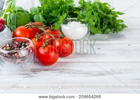 Tomatoes And Bunch Of Fresh Green Basil On A White Wood Background,