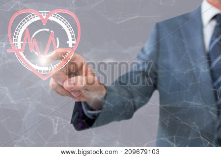 Midsection of businessman pointing against grey background