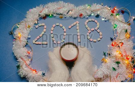 2018 year on blue background with hands