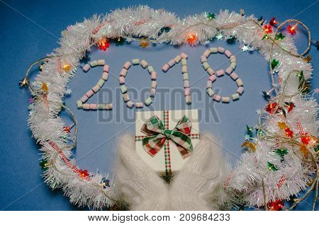 2018 year on blue background with hands