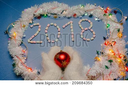2018 year on blue background with hands