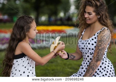 Healthy eating. Family lifesyle picnic, nature background. Happy leisure time in park, stylish and pretty females together