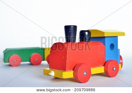 ooden train with locomotive and wagons, assembled with colored blocks, isolated on white background. part of a series