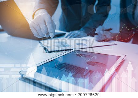 Business strategy invesment consept : Two businessman confident executive colleagues meeting and discussing at office with profit graph background.