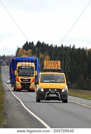 JOKIOINEN FINLAND - OCTOBER 13 2017: MAN TGX wide load truck transport by Silvasti Heavy is led by pilot vehicle along highway in South of Finland.