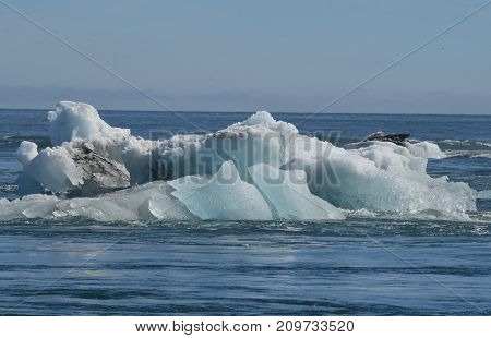 Stunning view of a large iceberg with sediment in a lagoon