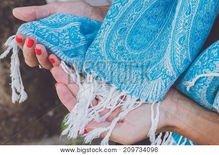 Yong woman hands with cashmere scarf. Bali island. Fashion shot.
